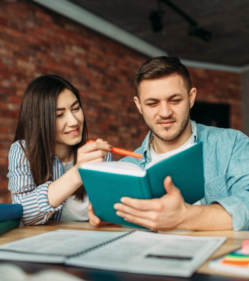 university-students-reading-textbook-together.jpg